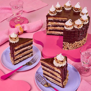 Ferrero Rocher Cake with eight layers of chocolate and hazelnut sponge, decorated with chocolate ganache and meringues.